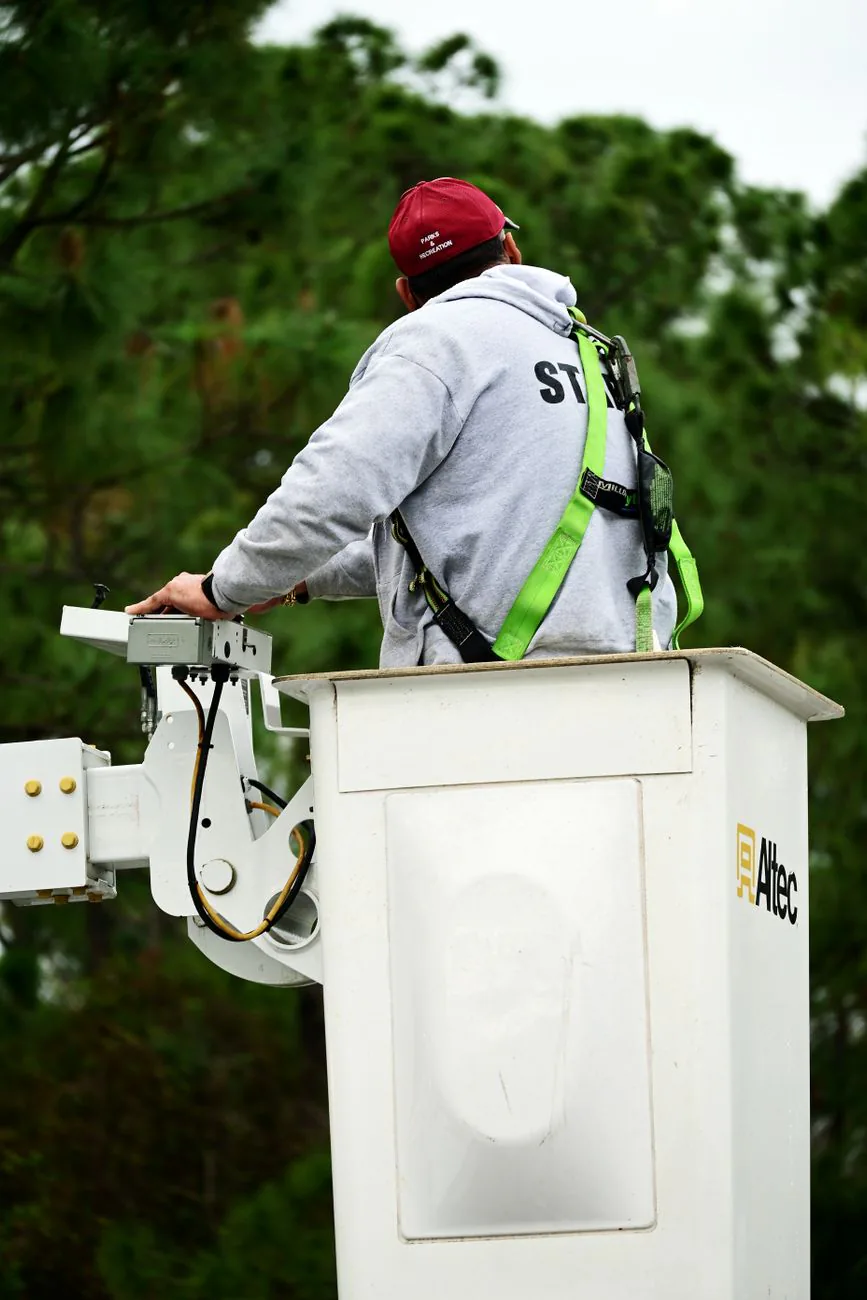 Tree removal worker operating a bucket truck